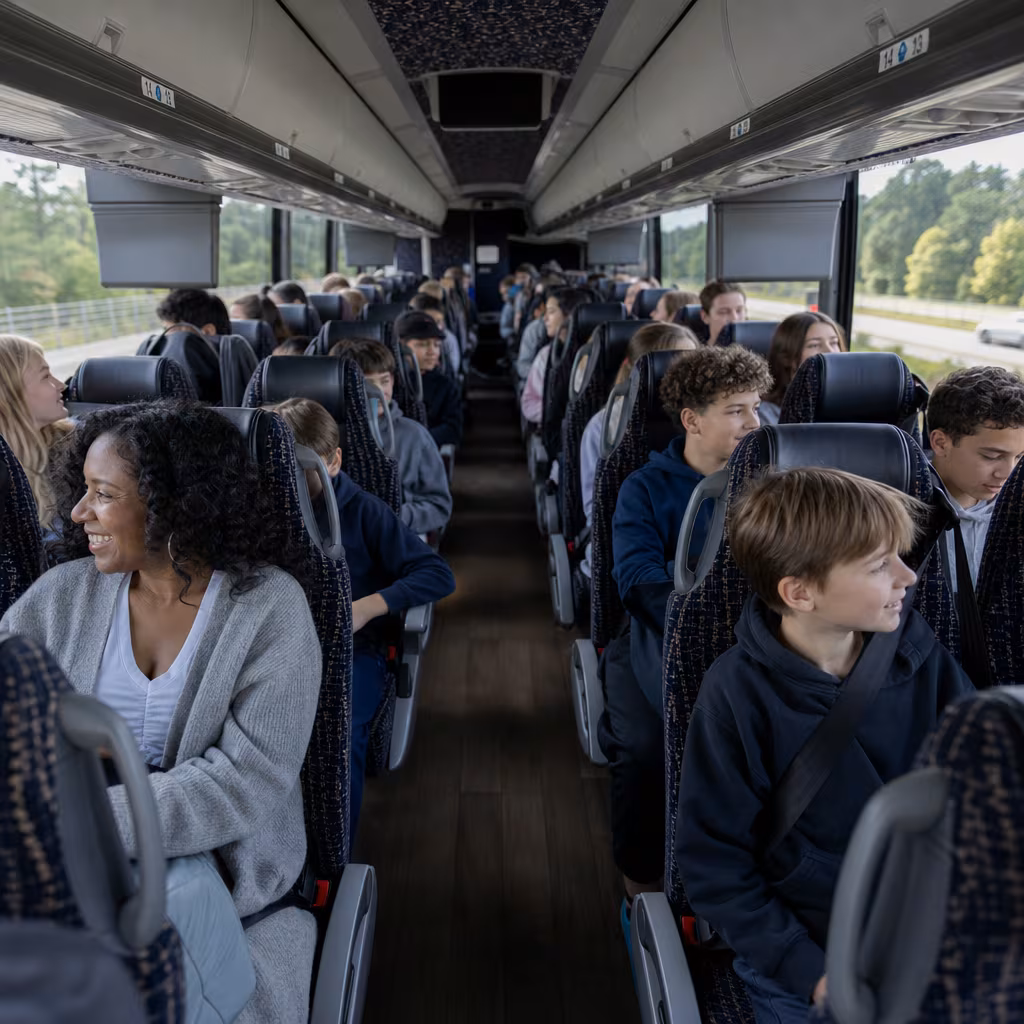 Group boarding a white charter bus for School Transportation transportation in San Francisco