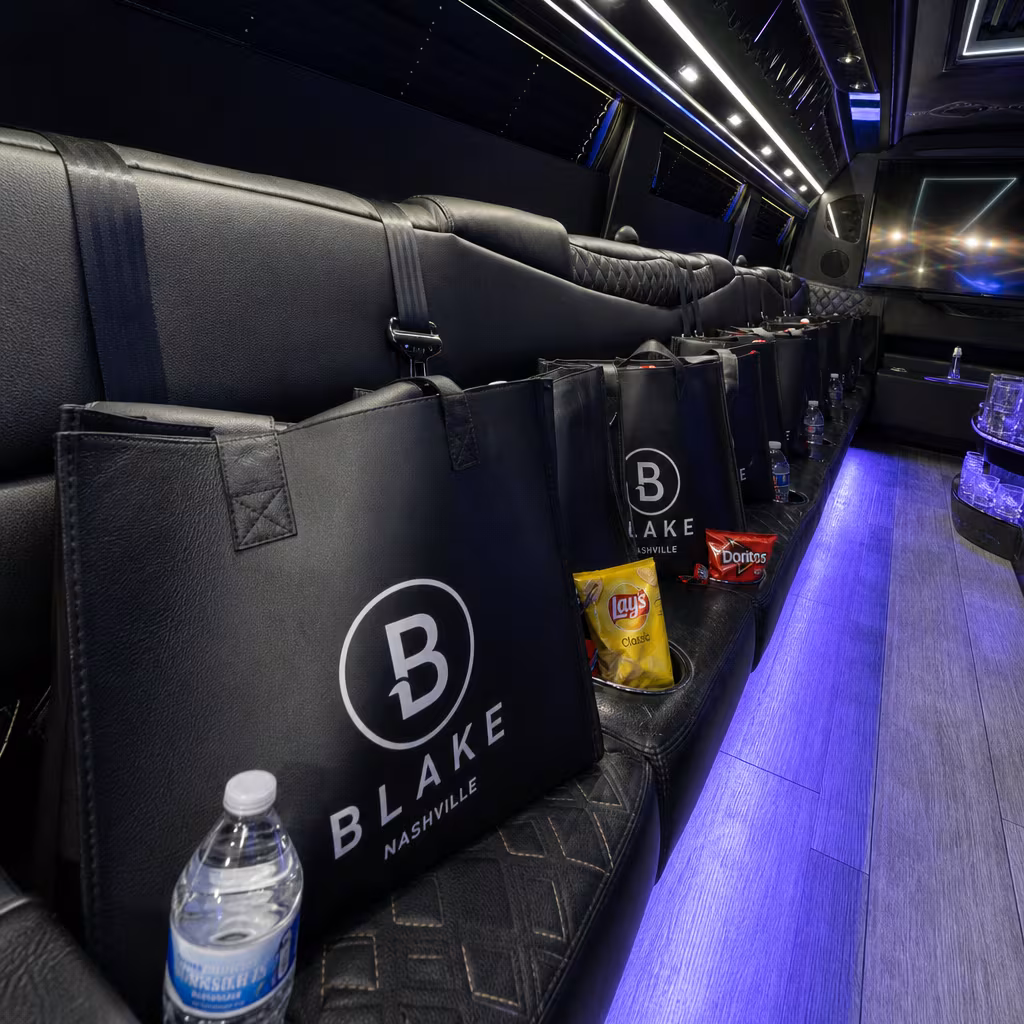 Party bus interior with wraparound leather seating and LED lighting in San Francisco